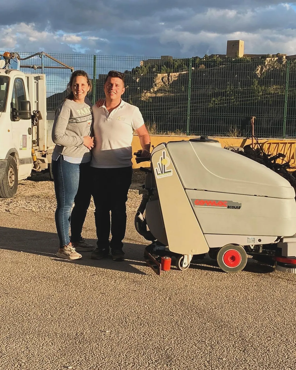 María del Mar y Diego junto a su barredora, con el castillo de Lorca al fondo